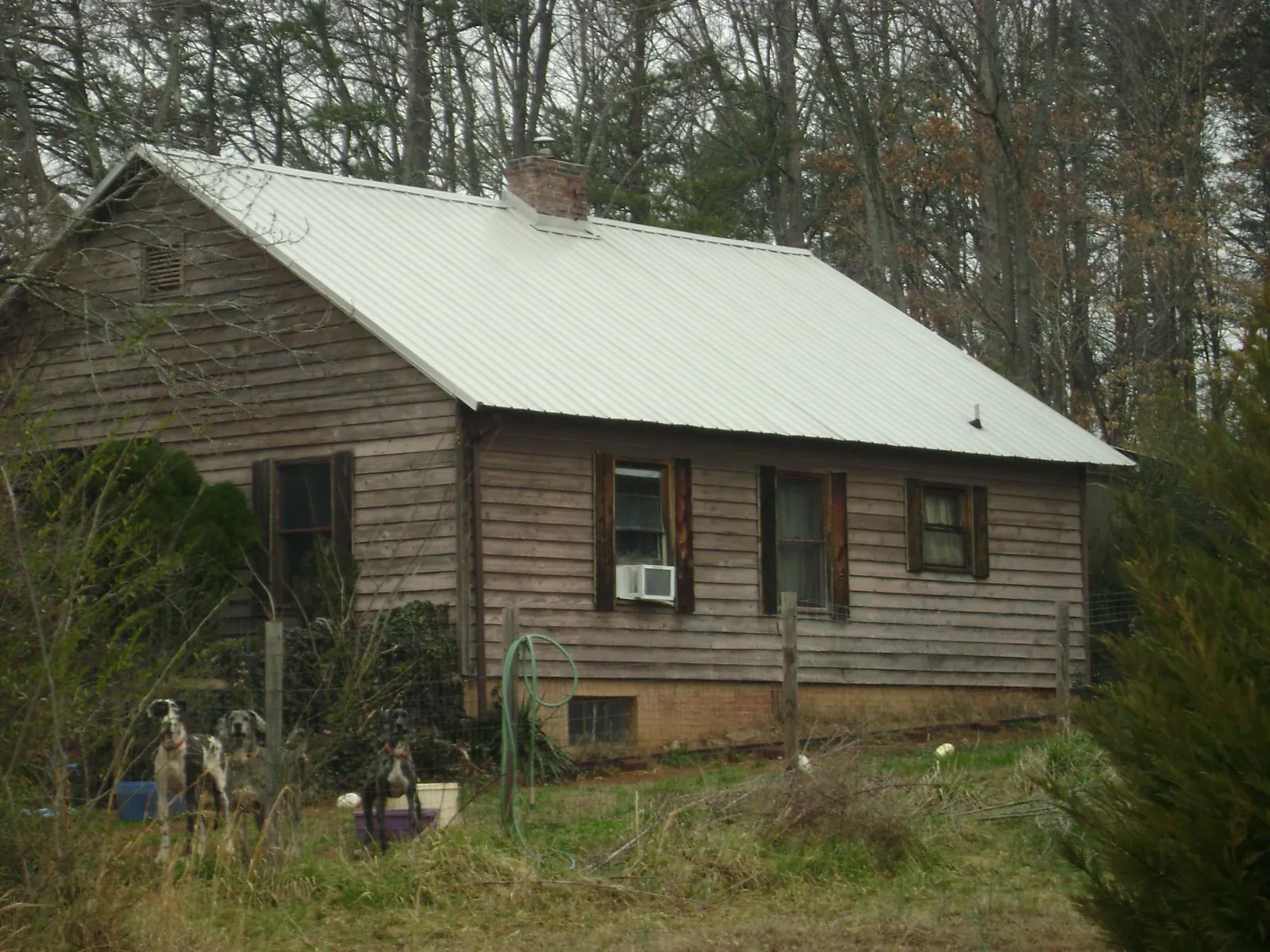 White metal roof on an old wood sided farmhouse, from a Metal Roof Installation job in Fe Warren Afb